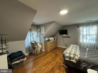 bedroom with hardwood / wood-style flooring and lofted ceiling