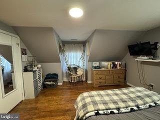 bedroom featuring lofted ceiling and dark wood-type flooring