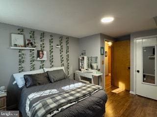 bedroom with dark hardwood / wood-style floors