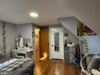 bedroom with dark hardwood / wood-style floors