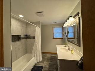 bathroom featuring vanity and shower / bath combination with curtain