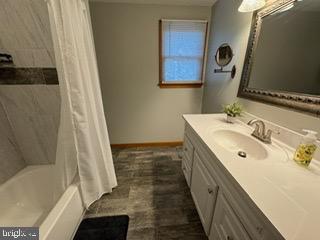 bathroom featuring vanity and shower / tub combo