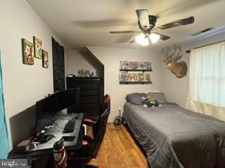 bedroom with ceiling fan and wood-type flooring