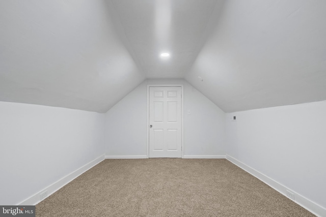 additional living space with lofted ceiling and carpet floors