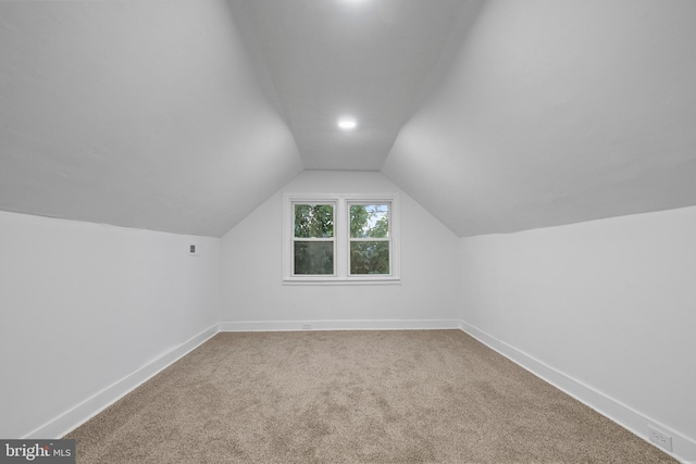 bonus room featuring vaulted ceiling and carpet flooring