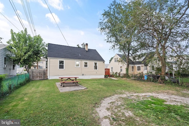 back of house featuring a yard and a patio