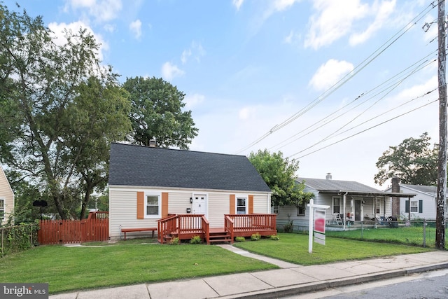 view of front of property with a wooden deck and a front yard