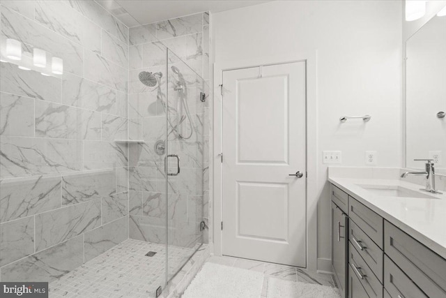 bathroom featuring vanity and a shower with door