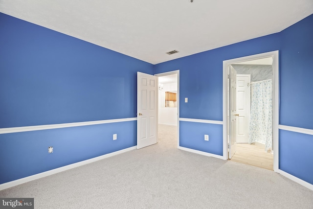 unfurnished bedroom with light colored carpet