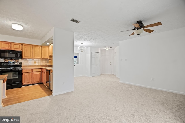 kitchen featuring backsplash, light colored carpet, a textured ceiling, and black appliances