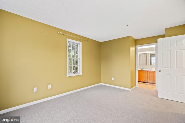 carpeted spare room featuring plenty of natural light