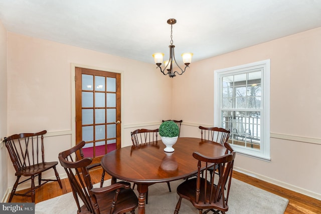 dining area featuring hardwood / wood-style floors and a chandelier