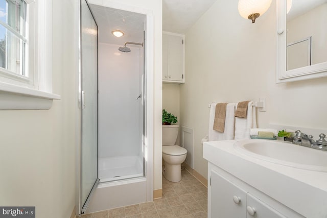 bathroom with vanity, toilet, and an enclosed shower