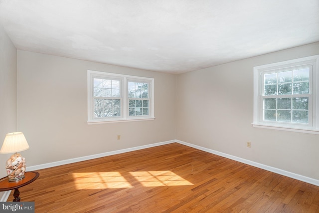 spare room with hardwood / wood-style flooring