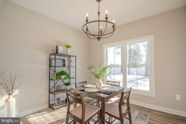 dining room with a chandelier and light hardwood / wood-style flooring