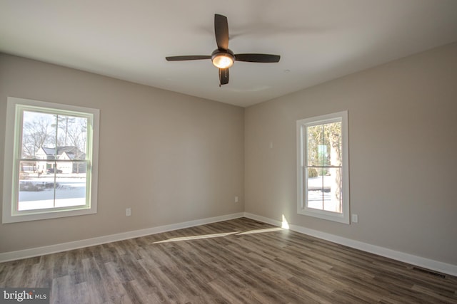 spare room featuring ceiling fan and dark hardwood / wood-style floors