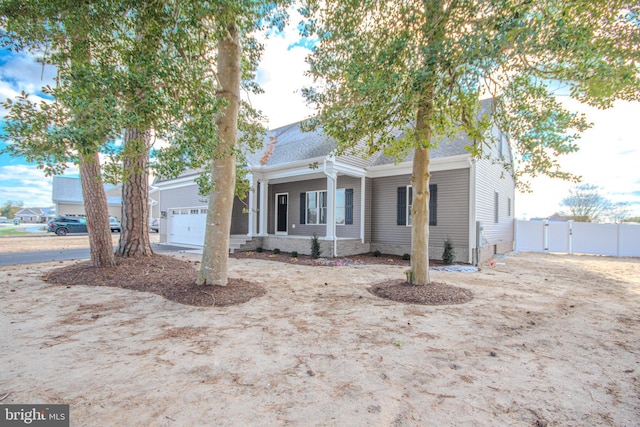 view of front of house with covered porch and a garage