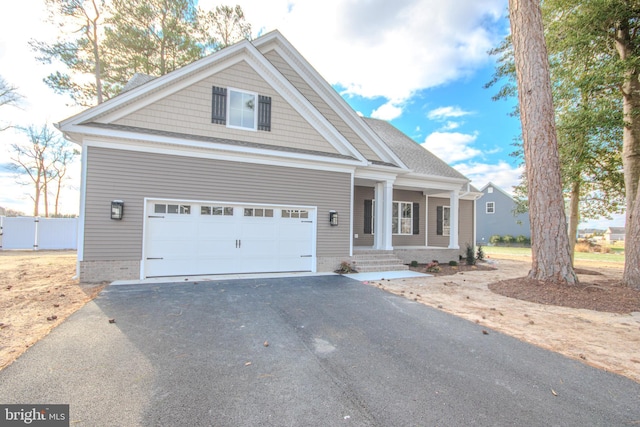 view of front of home with a porch and a garage