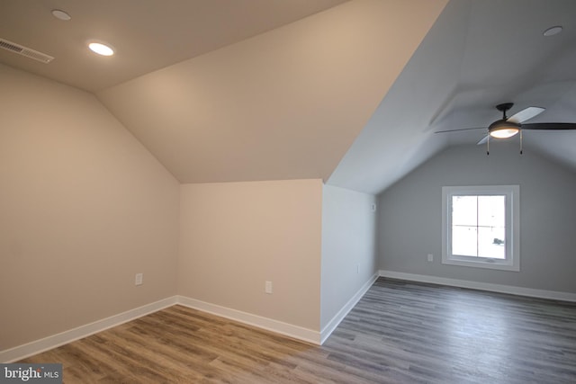 additional living space featuring hardwood / wood-style floors, ceiling fan, and lofted ceiling