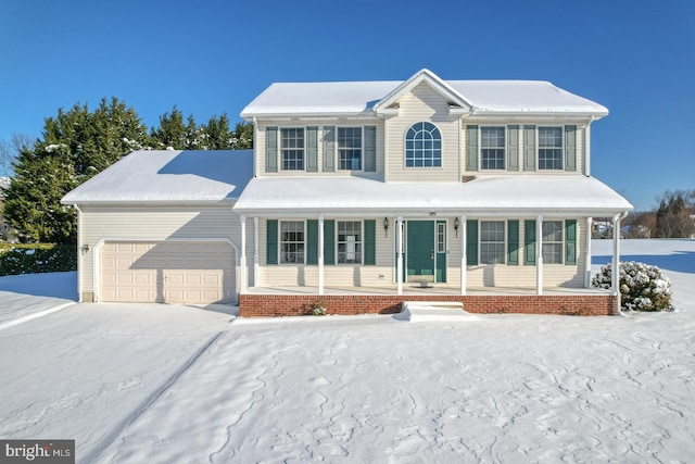 view of front of house featuring driveway, covered porch, and an attached garage