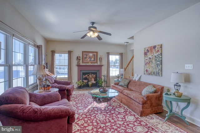 living room featuring light wood-type flooring and ceiling fan