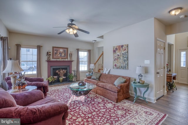 living room with light wood-type flooring and ceiling fan