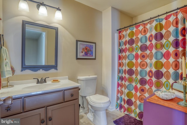 bathroom with tile patterned floors, toilet, and vanity