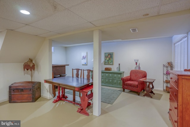 interior space with a paneled ceiling