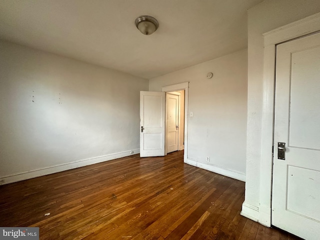 unfurnished bedroom featuring dark hardwood / wood-style floors