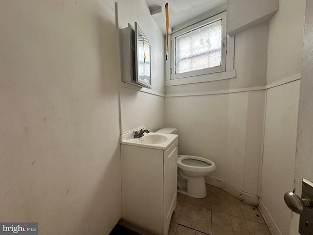 bathroom with tile patterned flooring, vanity, and toilet