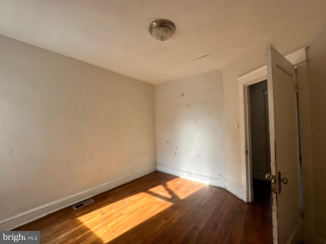 unfurnished room featuring dark hardwood / wood-style floors