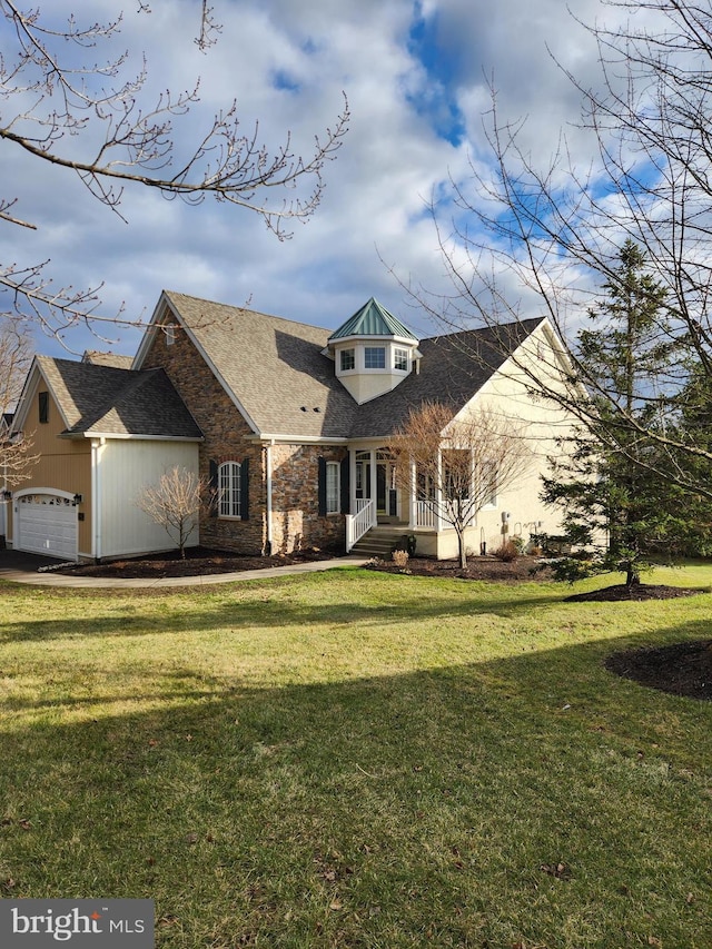 cape cod-style house featuring a front lawn and a garage