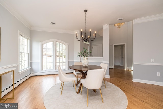 dining area with ornamental molding, light hardwood / wood-style flooring, a baseboard radiator, and a notable chandelier