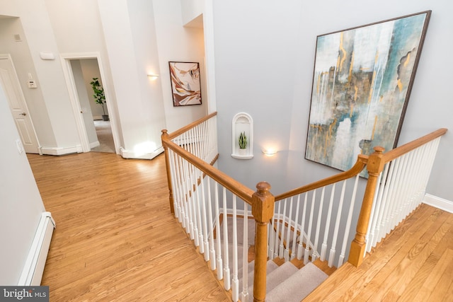 hall featuring light wood-type flooring and a baseboard radiator