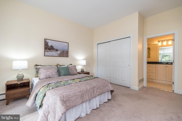 carpeted bedroom featuring a closet and a baseboard radiator