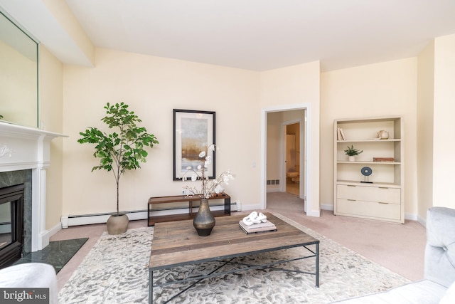 living room with a baseboard heating unit, a high end fireplace, and carpet flooring