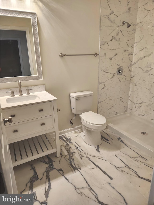 bathroom with a shower, vanity, and toilet