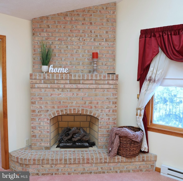 interior details with carpet flooring, a fireplace, and a baseboard heating unit