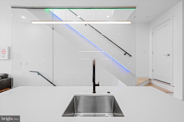 kitchen featuring white cabinets and sink