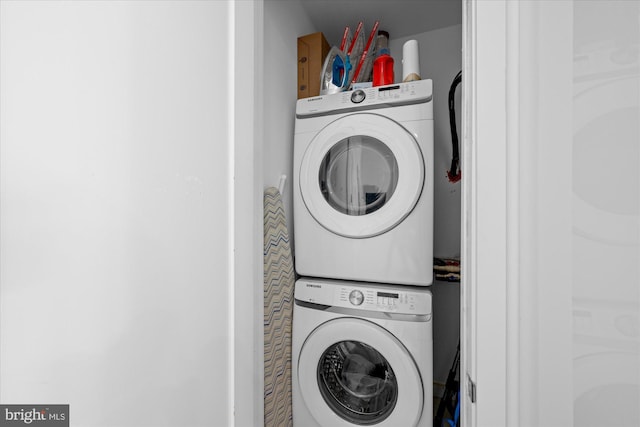 washroom featuring stacked washing maching and dryer