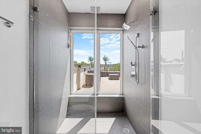 interior space with tile patterned floors and walk in shower