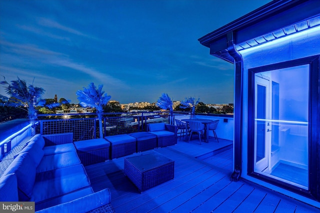 deck at dusk featuring an outdoor hangout area