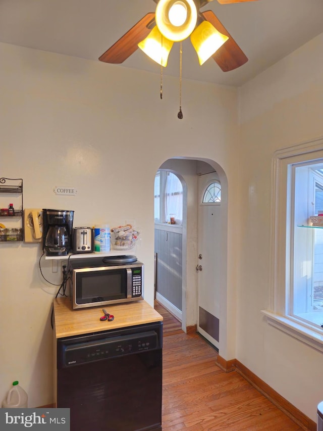 kitchen featuring ceiling fan, dishwasher, and light hardwood / wood-style floors