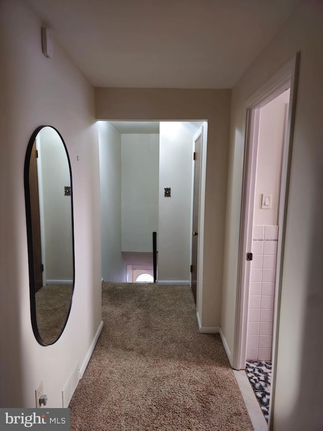 hallway featuring light carpet