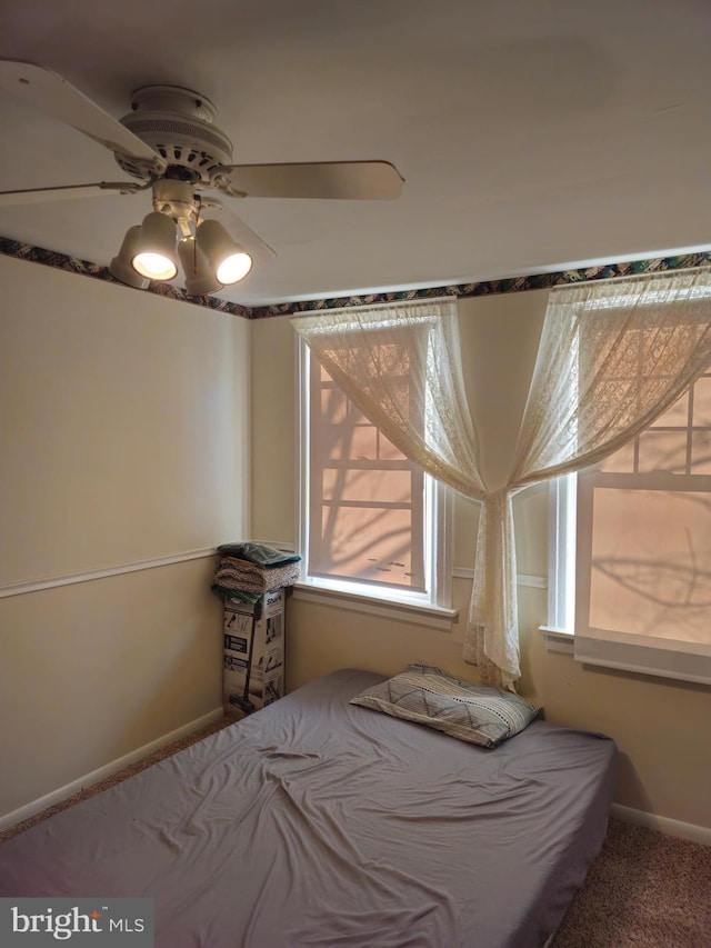 unfurnished bedroom with ceiling fan and carpet