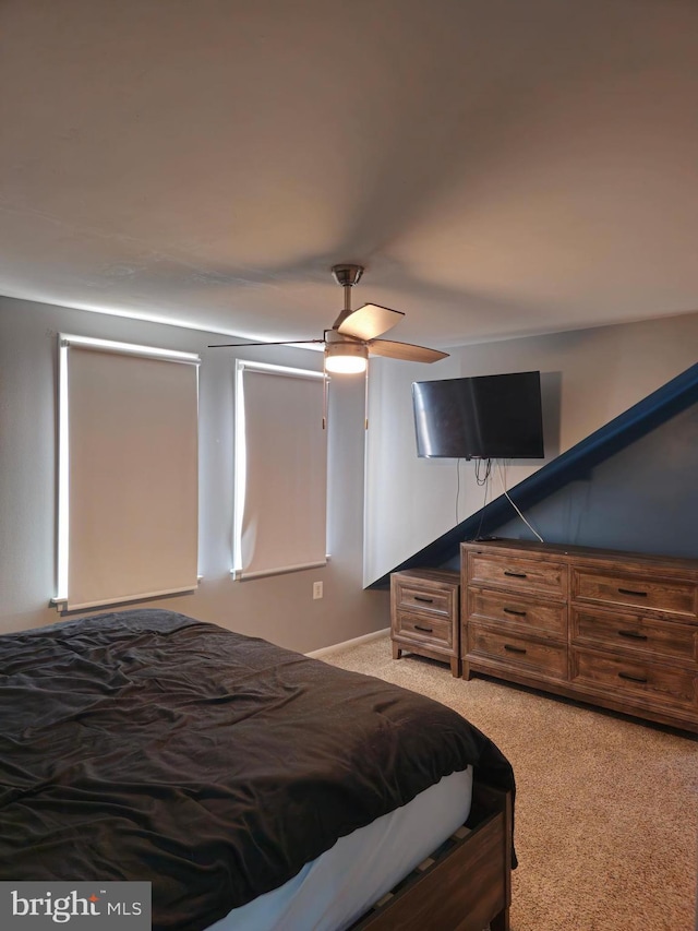 bedroom featuring light carpet and ceiling fan