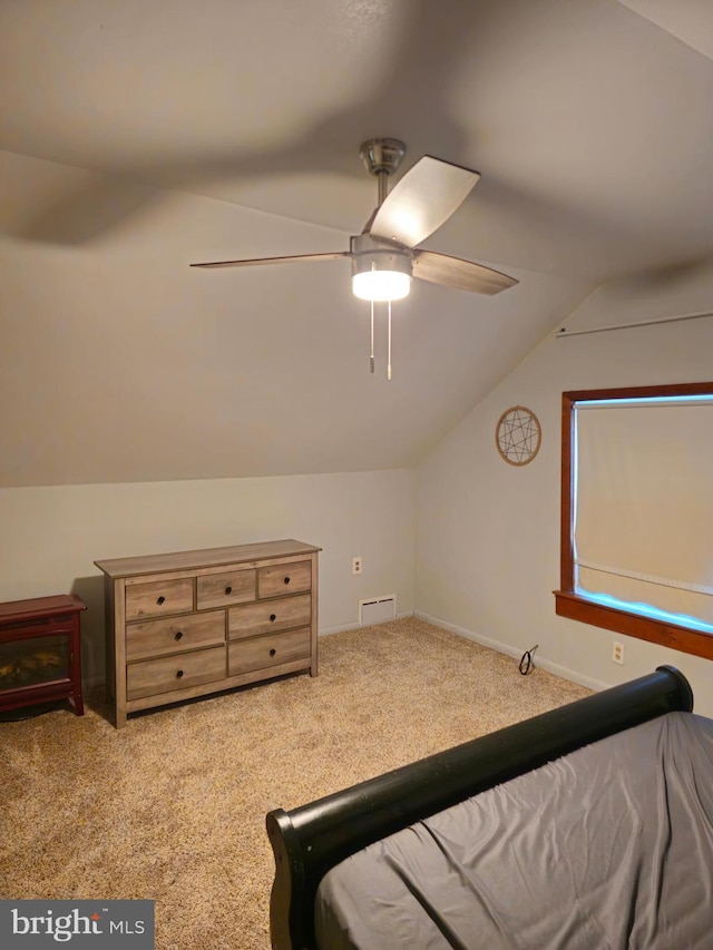 carpeted bedroom featuring ceiling fan and vaulted ceiling