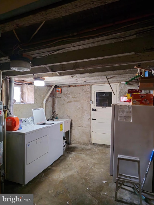 basement with sink, fridge, and independent washer and dryer