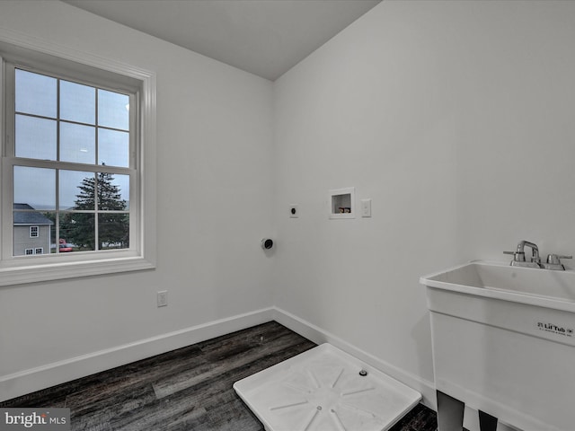 washroom with hookup for an electric dryer, washer hookup, dark hardwood / wood-style flooring, and sink