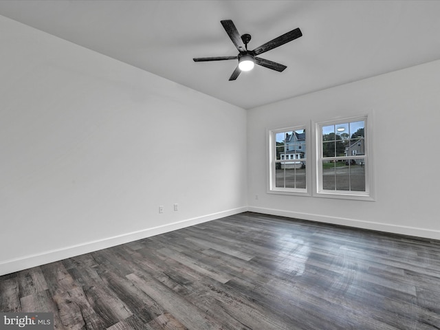 unfurnished room featuring dark hardwood / wood-style floors and ceiling fan